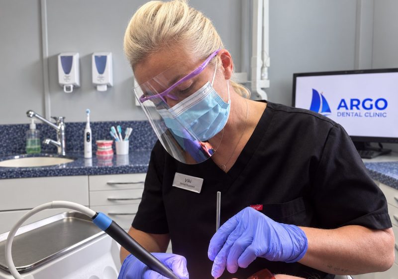 Viki, dental hygienist, treating a patient